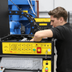 An engineer repairing an Ajan Plasma Cutter