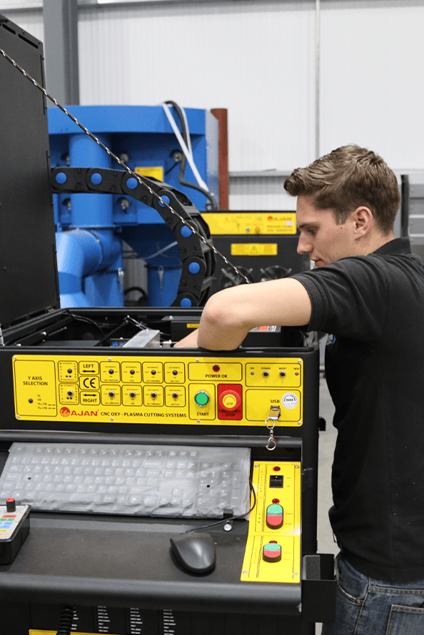 An engineer repairing an Ajan Plasma Cutter