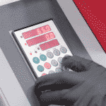 Close up of a hand operating the Elgo Controller