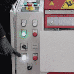 Image of the front of the machine with hand pointing at the controls