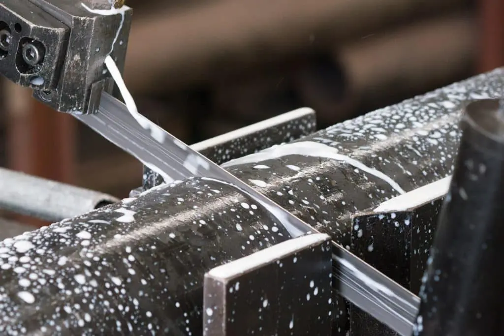 Image of metalworking saw blade cutting through solid tube