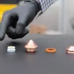 Image of a hand pointing at Ajan Plasma Torch Consumable