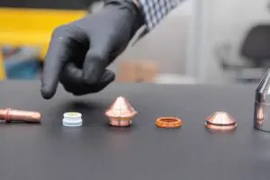 Image of a hand pointing at Ajan Plasma Torch Consumable