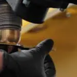Close up image of a hand removing the Shield Cap on the Ajan Plasma Torch