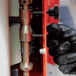 Close up of a hand adjusting the stroke limit switches on a steelworker