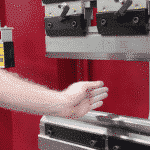 Operator demonstrating the laser light guard on the front of Morgan Rushworth Press Brake