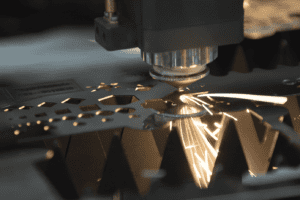 Close up of Laser Cutting head cutting intricate sections on a metal sheet