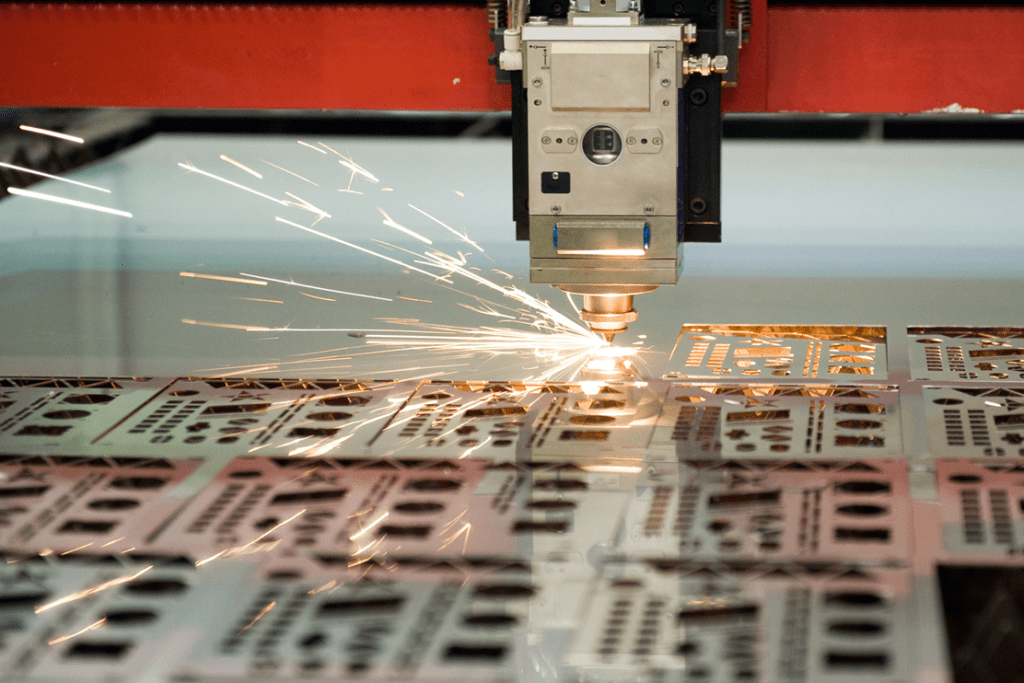 Close up image of the cutting head cutting metal on a Fibre Laser