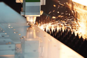 Close up image of the Raytool cutting head cutting metal on a Fibre Laser