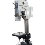 Meyer SR70TAE pillar drill featuring a tall grey column, black motor housing, red safety switch, large adjustable worktable with crank handle, and a sturdy base designed for industrial use.