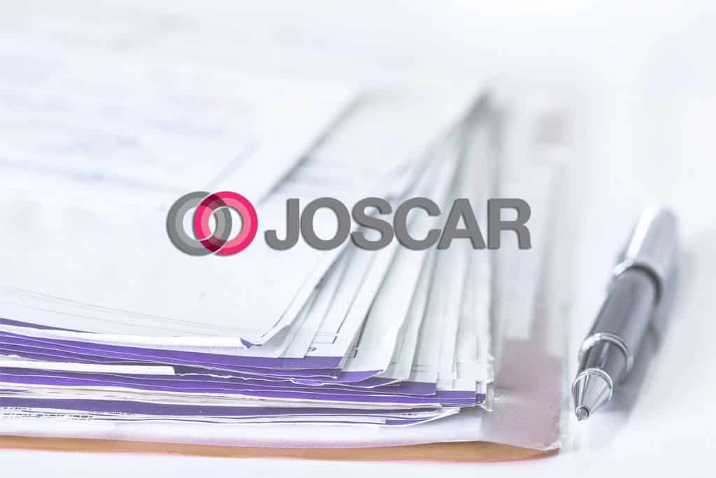Image of the Joscar logo with paperwork in the background
