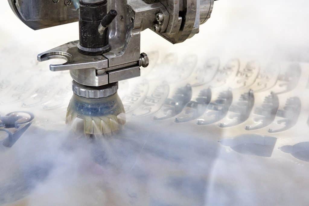 Image of waterjet nozzle cutting metal