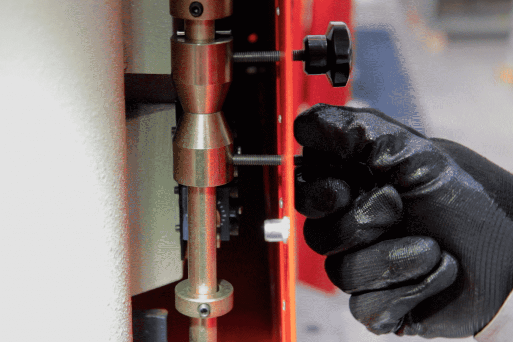 Close up of a hand adjusting the stroke limit switches on a steelworker