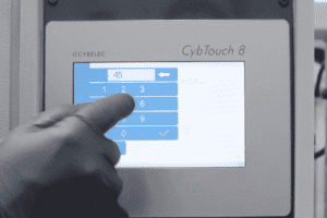 Image of a hand operating the Cybtouch 8 Control Panel