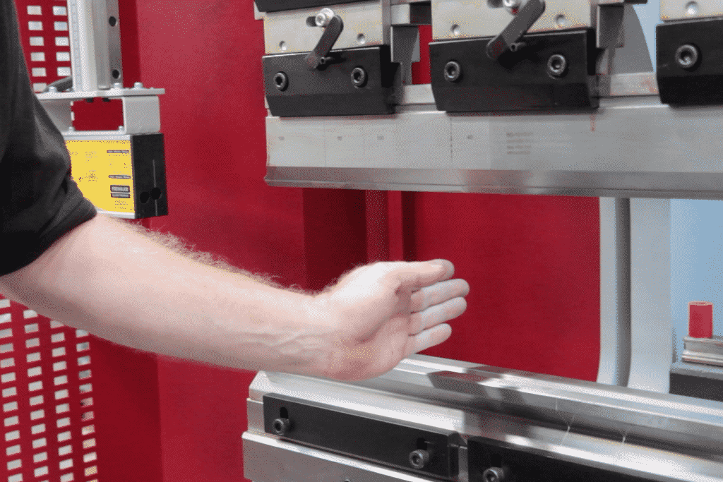 Operator demonstrating the laser light guard on the front of Morgan Rushworth Press Brake