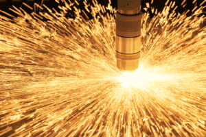 Close up of a hypertherm plasma torch sparking whilst cutting