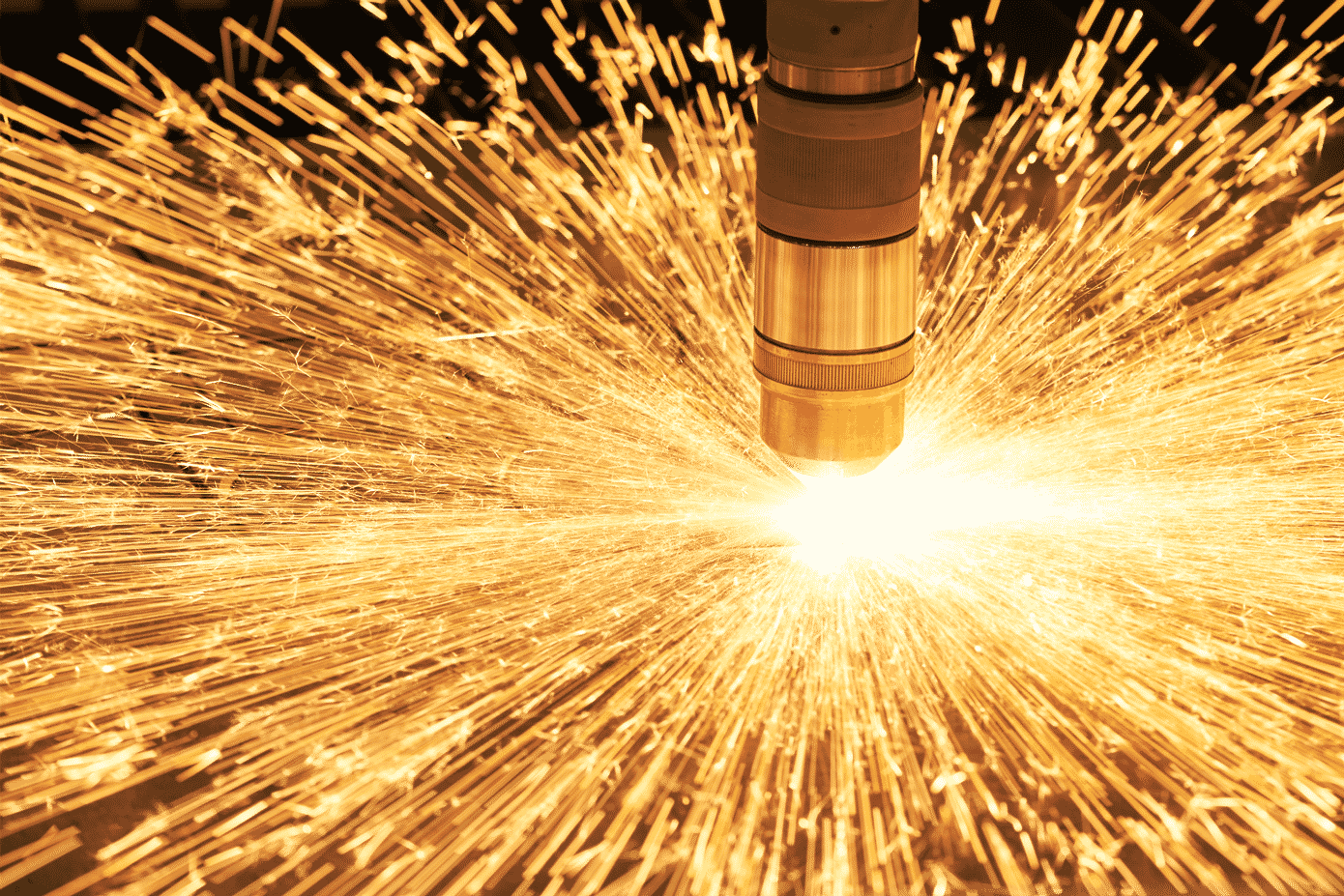 Close up of a hypertherm plasma torch sparking whilst cutting