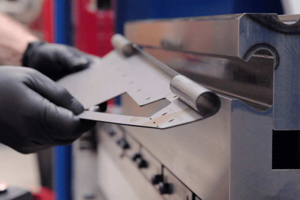 Close up metal being curled on a press brake