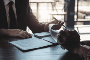 Image of two people reviewing documents and cash