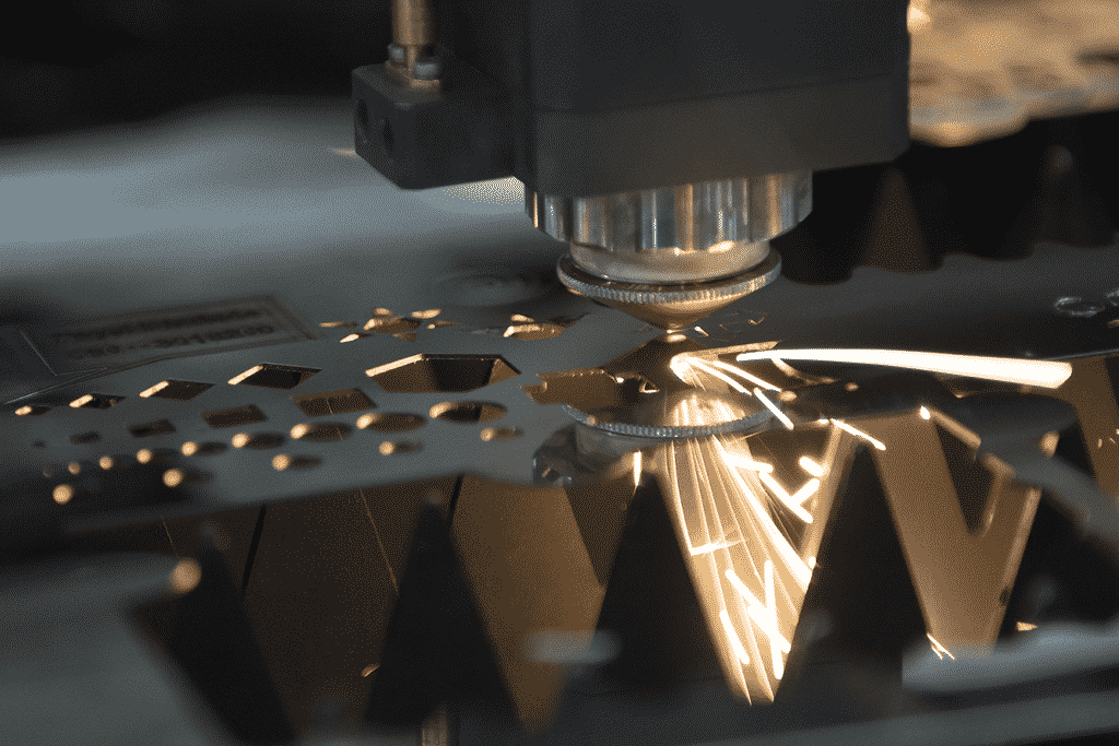 Close up of Laser Cutting head cutting intricate sections on a metal sheet