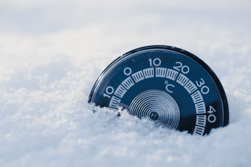 Image of a gauge in snow showing minus figures