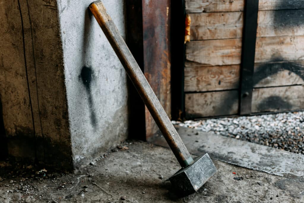 old sledgehammer standing in garage