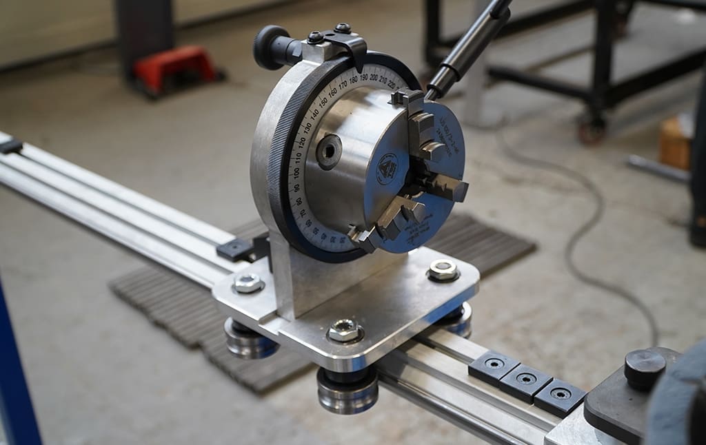 The adjustable angle chuck with a plane-of-bend indicator